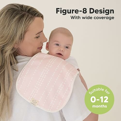 Woman holding a baby with a pink burp cloth on her shoulder